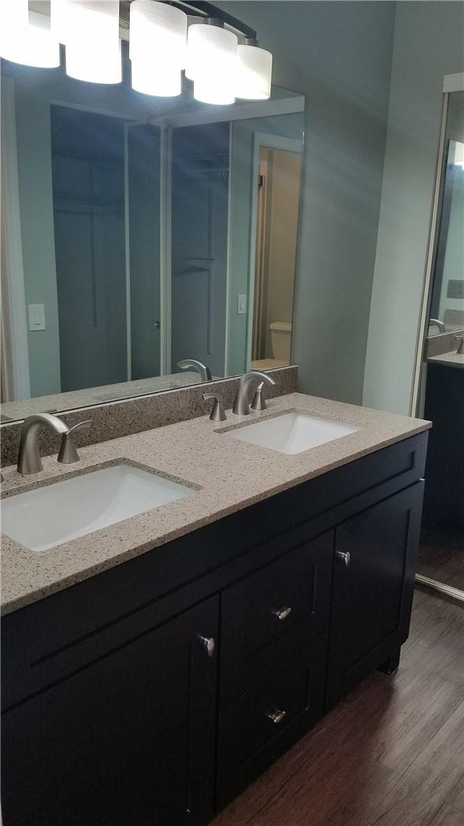 6659 Via Regina, Unit 6659 Boca Raton, FL 33433 - Photo 14 of 38 a bathroom with a double vanity sink and a mirror