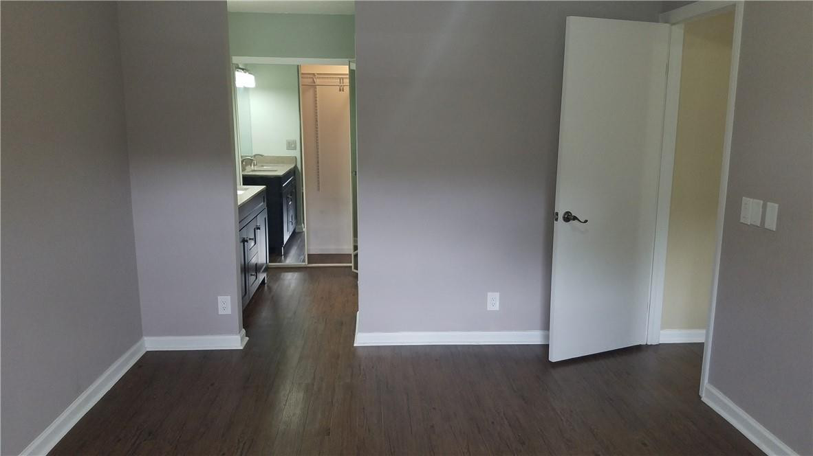 6659 Via Regina, Unit 6659 Boca Raton, FL 33433 - Photo 15 of 38 an empty room with wooden floor and closet