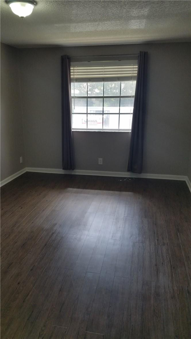 6659 Via Regina, Unit 6659 Boca Raton, FL 33433 - Photo 16 of 38 an empty room with wooden floor and windows