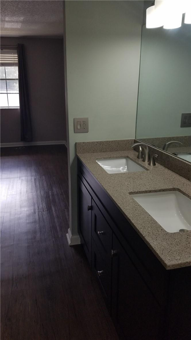 6659 Via Regina, Unit 6659 Boca Raton, FL 33433 - Photo 18 of 38 a bathroom with a granite countertop sink and a mirror
