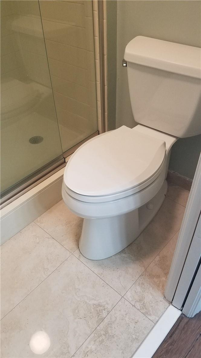 6659 Via Regina, Unit 6659 Boca Raton, FL 33433 - Photo 19 of 38 a white toilet sitting next to a bath tub