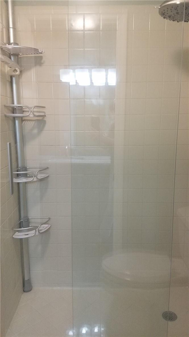 6659 Via Regina, Unit 6659 Boca Raton, FL 33433 - Photo 20 of 38 a bathroom with a glass shower door