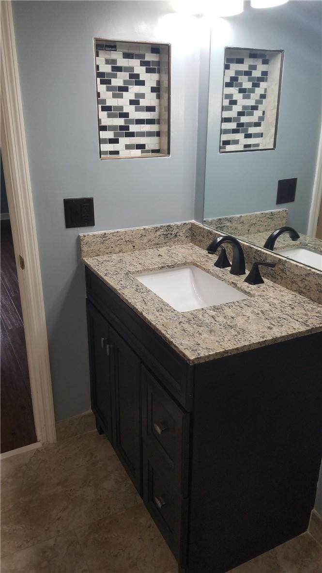 6659 Via Regina, Unit 6659 Boca Raton, FL 33433 - Photo 23 of 38 a bathroom with a granite countertop sink and a mirror