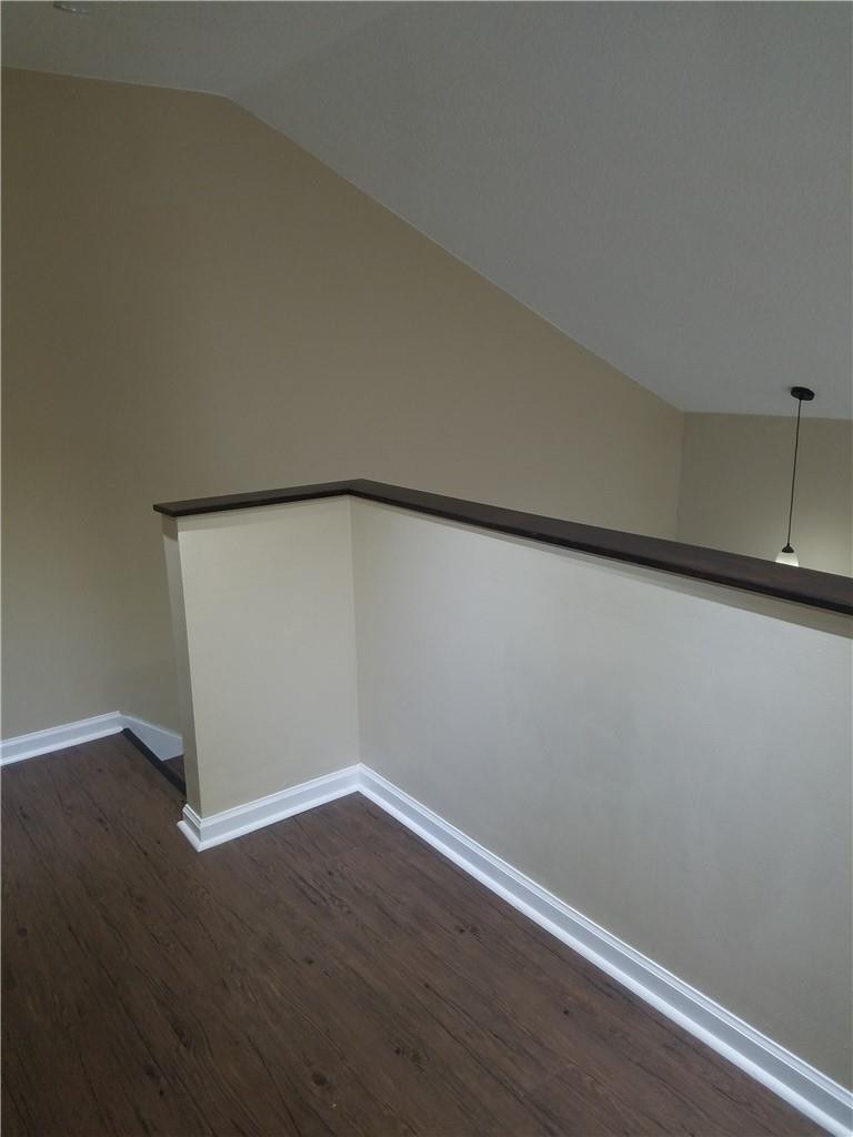 6659 Via Regina, Unit 6659 Boca Raton, FL 33433 - Photo 27 of 38 a view of an empty room with wooden floor