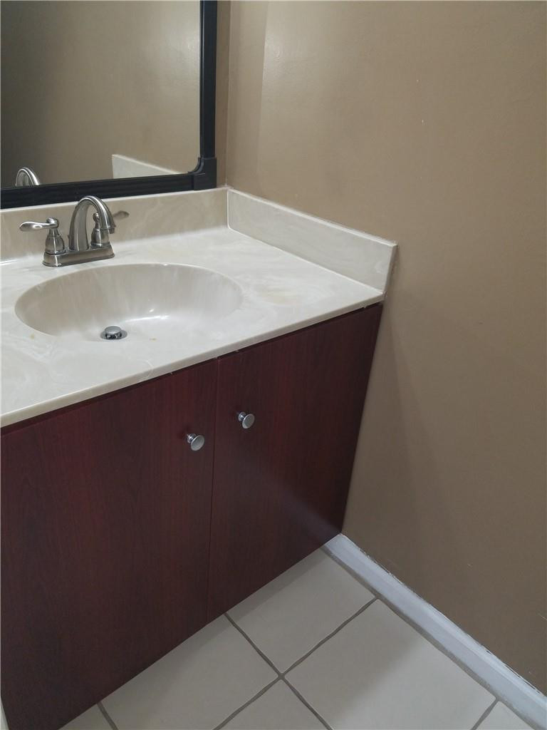 6659 Via Regina, Unit 6659 Boca Raton, FL 33433 - Photo 28 of 38 a bathroom with a sink and a mirror