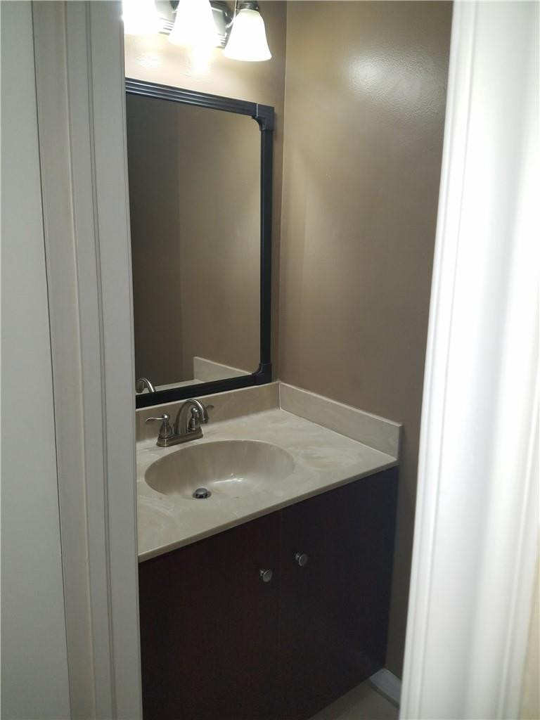 6659 Via Regina, Unit 6659 Boca Raton, FL 33433 - Photo 29 of 38 a bathroom with a sink and mirror