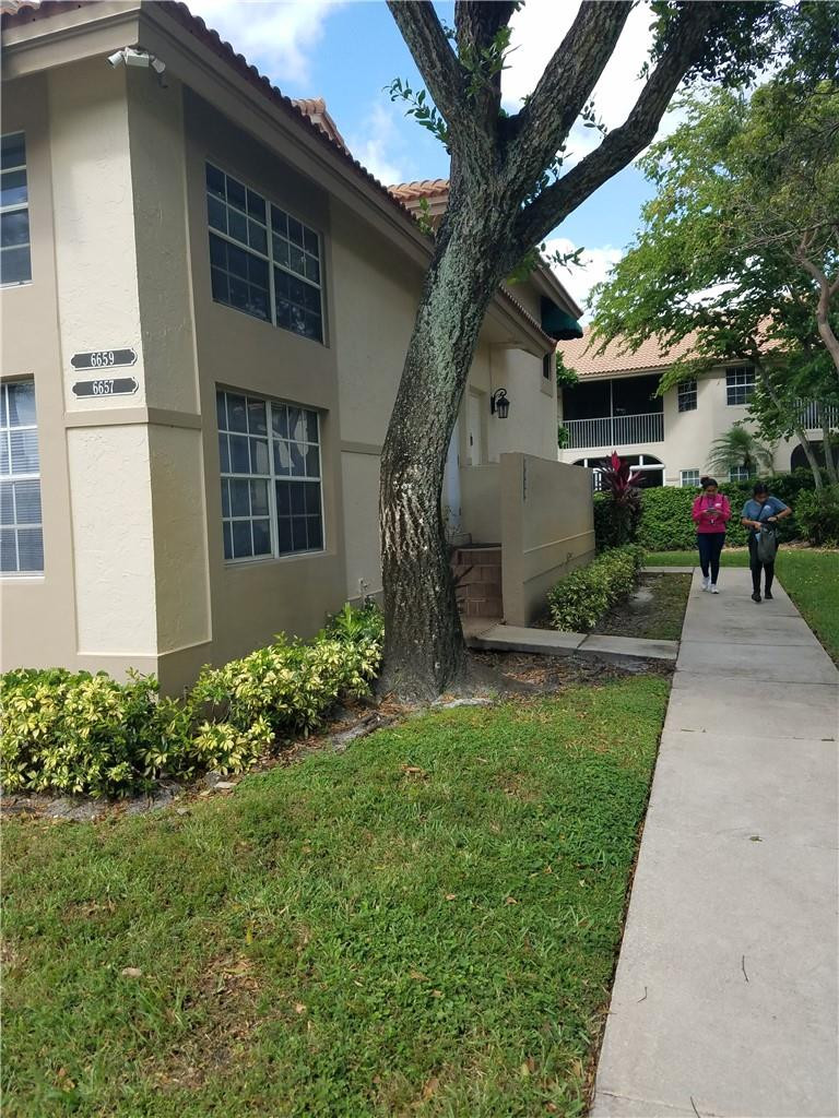 6659 Via Regina, Unit 6659 Boca Raton, FL 33433 - Photo 35 of 38 a front view of a house with garden