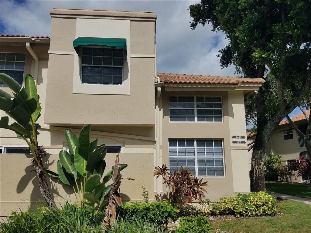 6659 Via Regina, Unit 6659 Boca Raton, FL 33433 - Photo 36 of 38 a front view of a house with garden