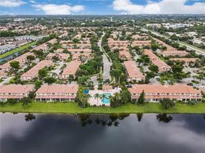 6659 Via Regina, Unit 6659 Boca Raton, FL 33433 - Photo 38 of 38 an aerial view of a house with a yard and lake view