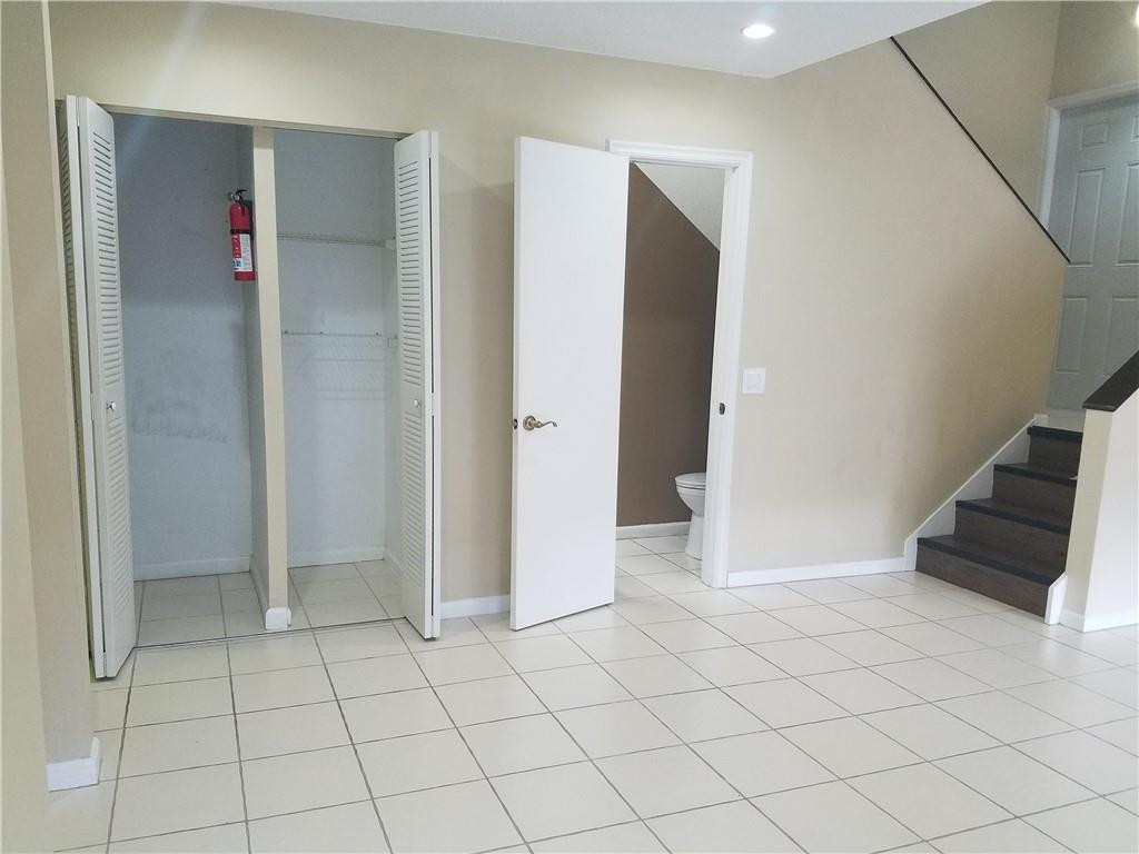 6659 Via Regina, Unit 6659 Boca Raton, FL 33433 - Photo 6 of 38 an empty room with cabinet and mirrors
