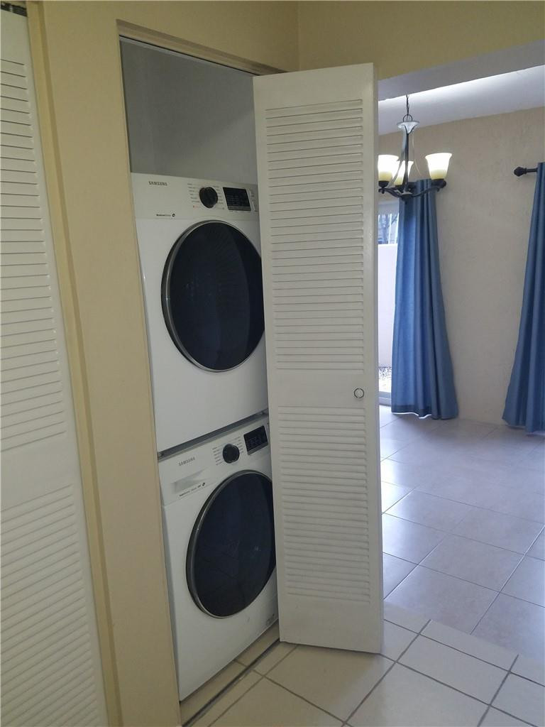6659 Via Regina, Unit 6659 Boca Raton, FL 33433 - Photo 10 of 38 a view of a hallway with washer and dryer