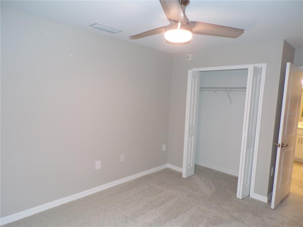14271 Heritage Landing Boulevard, Unit 1526 Punta Gorda, FL 33955 - Photo 11 of 41 an empty room with a empty space and a ceiling fan