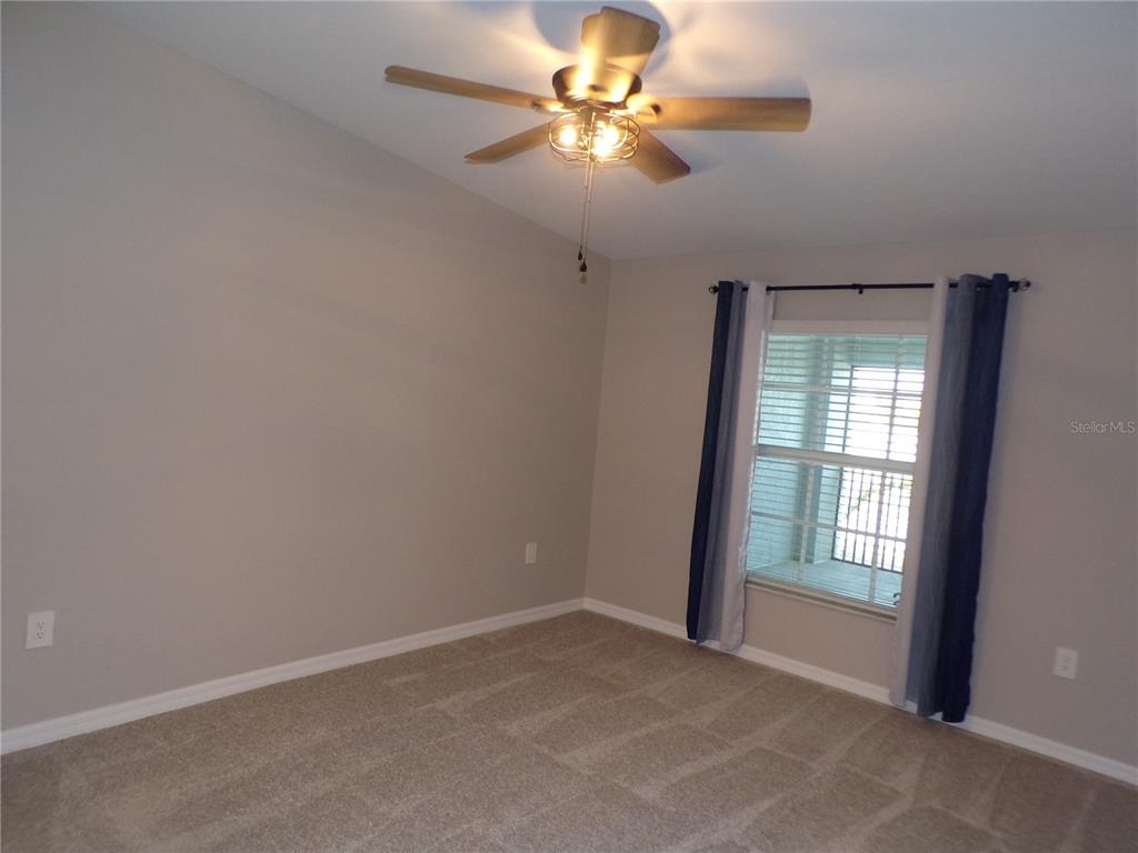 14271 Heritage Landing Boulevard, Unit 1526 Punta Gorda, FL 33955 - Photo 18 of 41 an empty room with windows and fan