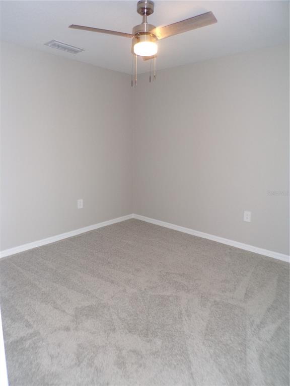 14271 Heritage Landing Boulevard, Unit 1526 Punta Gorda, FL 33955 - Photo 20 of 41 an empty room with a window and a ceiling fan