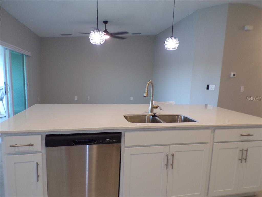 14271 Heritage Landing Boulevard, Unit 1526 Punta Gorda, FL 33955 - Photo 23 of 41 a kitchen with a sink and a refrigerator