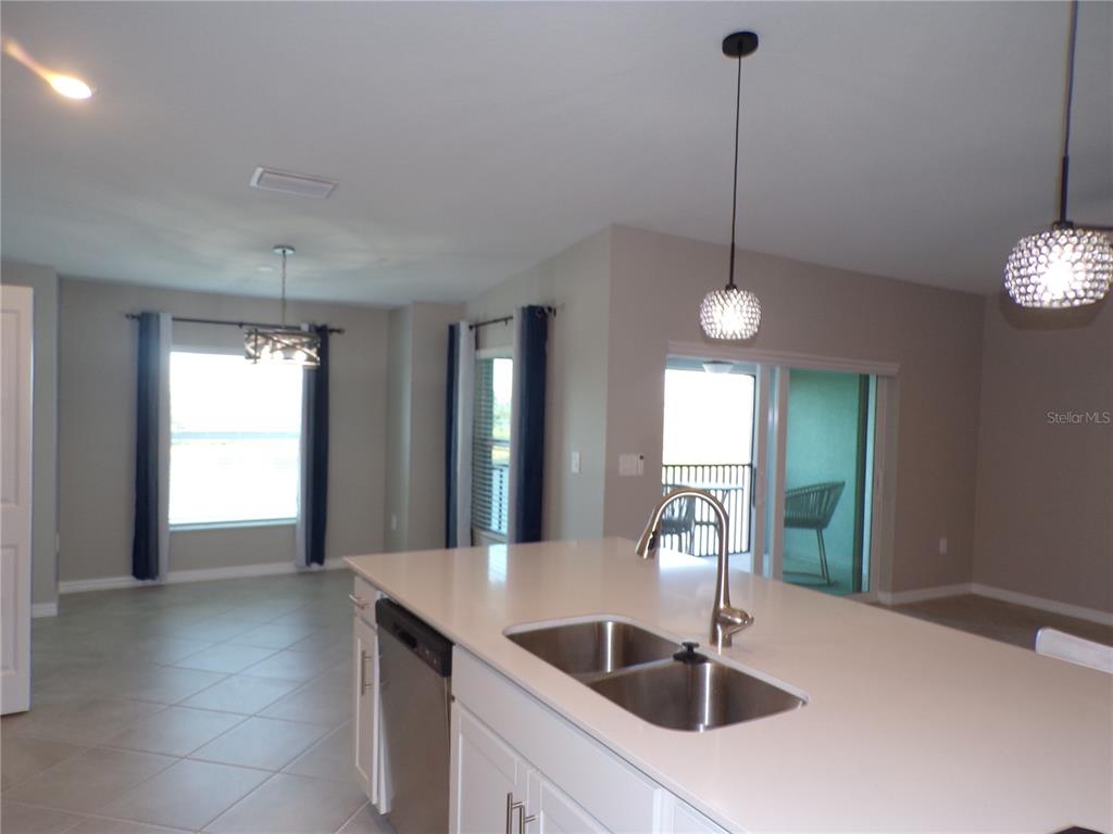14271 Heritage Landing Boulevard, Unit 1526 Punta Gorda, FL 33955 - Photo 30 of 41 a kitchen with stainless steel appliances a sink and chandelier
