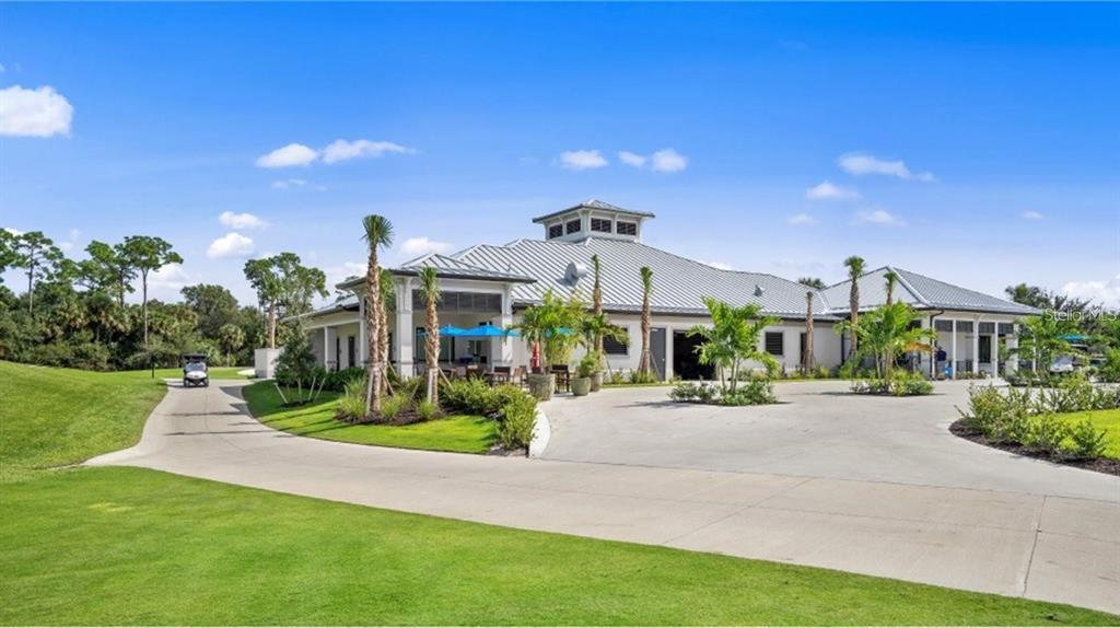 14271 Heritage Landing Boulevard, Unit 1526 Punta Gorda, FL 33955 - Photo 39 of 41 a front view of a house with a yard and potted plants