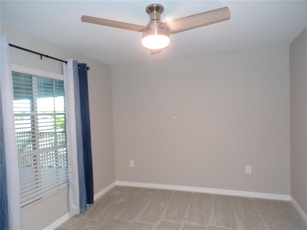 14271 Heritage Landing Boulevard, Unit 1526 Punta Gorda, FL 33955 - Photo 10 of 41 an empty room with windows and fan
