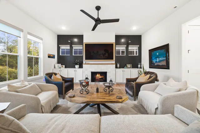 a living room with furniture a fireplace and a flat screen tv
