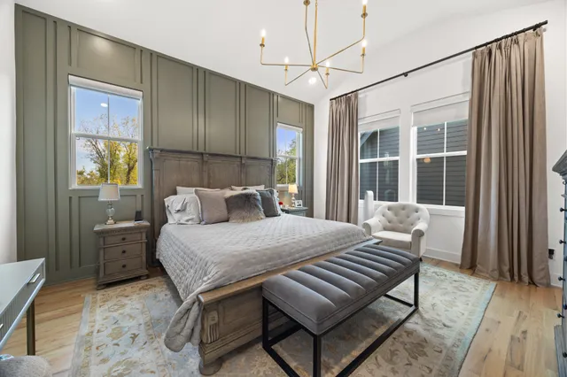 a bed sitting in a spacious bedroom next to a window