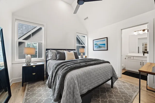 a bedroom with a bed and wooden floor