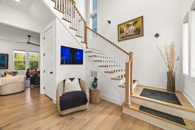 a living room with furniture and stairs