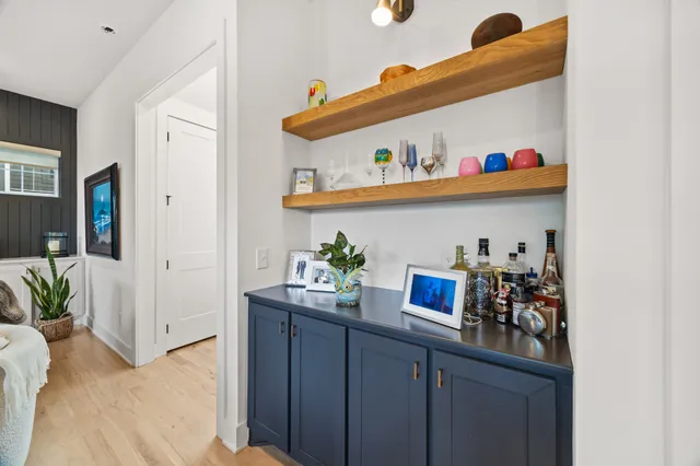 a kitchen with stainless steel appliances cabinets and a wooden floor
