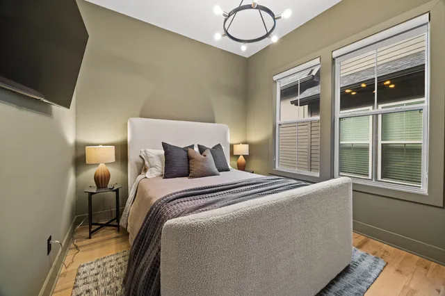 a bed sitting in a bedroom next to a window