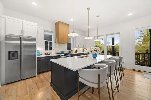 a kitchen with kitchen island a counter top space appliances and cabinets