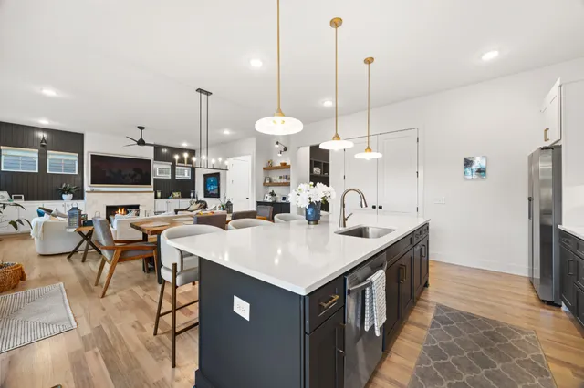 a kitchen with a sink a counter and chairs