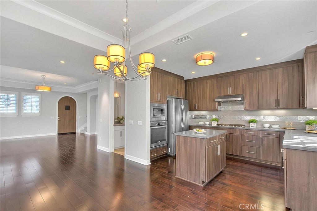 1058 Sunset Boulevard, Unit B Arcadia, CA 91007 - Photo 9 of 45 a kitchen with stainless steel appliances granite countertop a refrigerator a sink dishwasher a microwave oven and a dining table with wooden floor