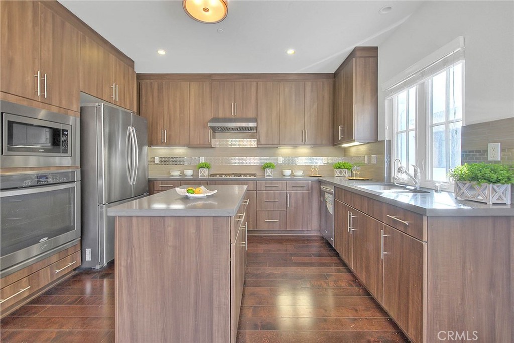 1058 Sunset Boulevard, Unit B Arcadia, CA 91007 - Photo 10 of 45 a kitchen with kitchen island granite countertop wooden cabinets a refrigerator and a sink