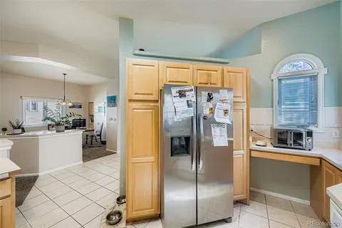 a kitchen with stainless steel appliances granite countertop a refrigerator and a stove top oven