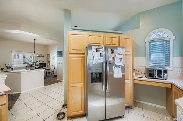a kitchen with stainless steel appliances granite countertop a refrigerator and a stove top oven