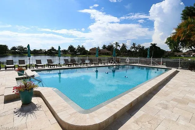 a view of a swimming pool with a lounge chair