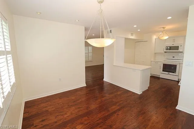 a view of a kitchen with wooden floor and a sink