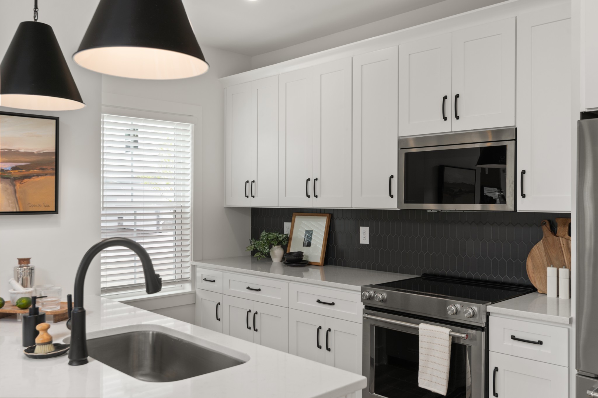 a kitchen with stainless steel appliances a stove a sink a refrigerator and cabinets