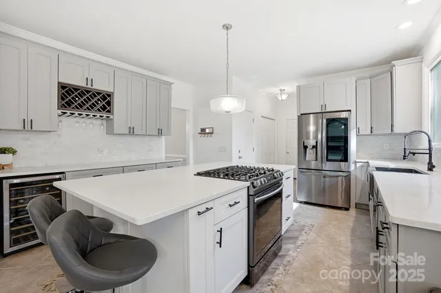 a kitchen with a stove a sink and a refrigerator