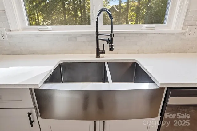 a view of a sink a window and a rug