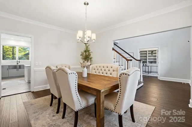 a view of a dining room with furniture wooden floor and chandelier