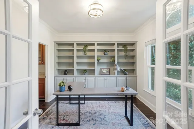 a view of a workspace with furniture and a window