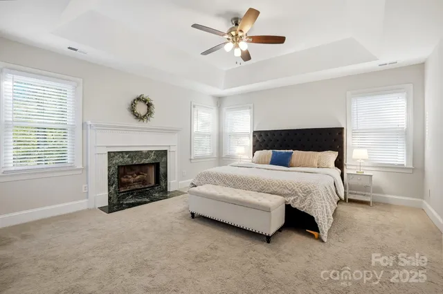 a bedroom with a bed and a fireplace