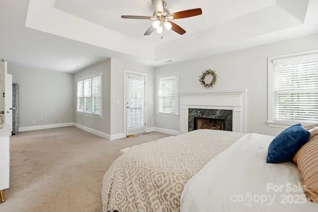 a spacious bedroom with a large bed and a chandelier