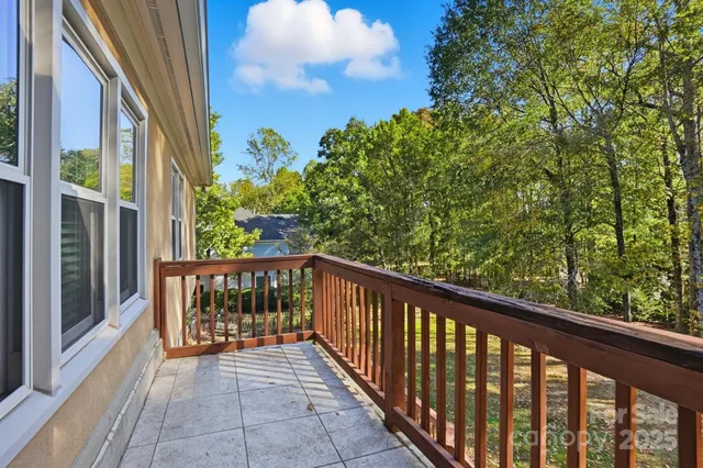 a view of a balcony with wooden floor and outdoor space