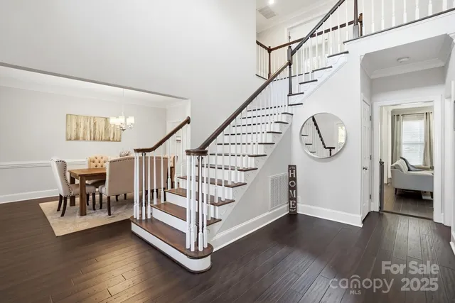 a view of entryway with wooden floor and stairs