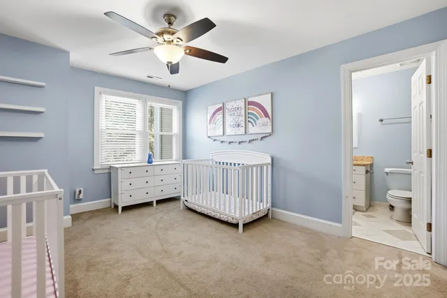 a view of an empty room with a window and a ceiling fan