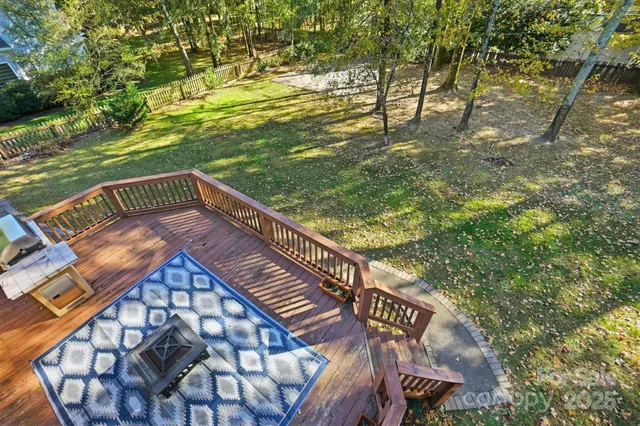 a view of balcony with wooden floor and fence