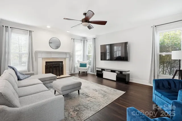 a living room with furniture flat screen tv and a fireplace