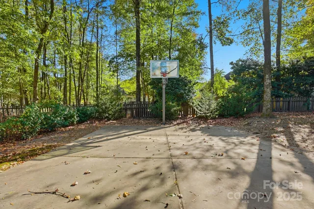 a view of swimming pool with a garden and plants