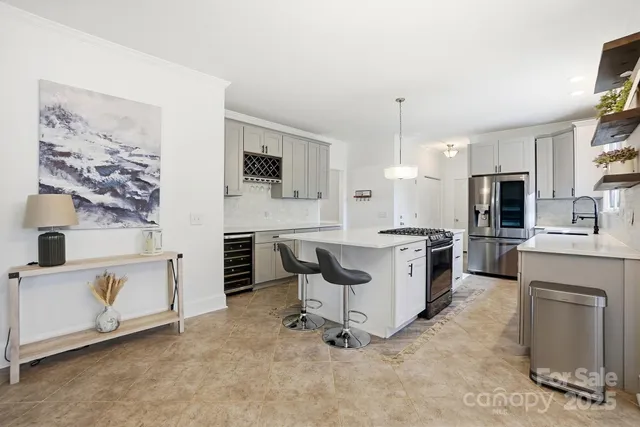 a kitchen with white cabinets and appliances